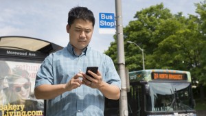 PhD student Adrian deFreitas uses Impromptu, a system that accesses shared apps only when needed, such as a public transit app when the user is standing near a bus stop