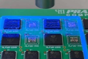 A needle-deposited rectangular wall of Dow CC-8036 acts as a dam for the sprayed CC-8033 infill. UV accompanying the spray head cures it all